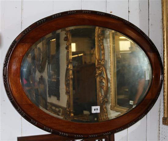 Mahogany oval framed mirror(-)